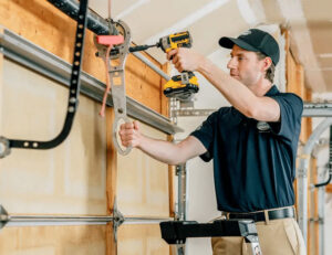 Technician replacing a garage door spring using a SureWinder system by NextLevel Garage Co. in Bainbridge Island, WA